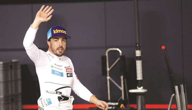 In this November 24, 2018, picture, McLaren driver Fernando Alonso waves to spectators in the pitlane during the qualifying session in Abu Dhabi, United Arab Emirates. (Reuters)