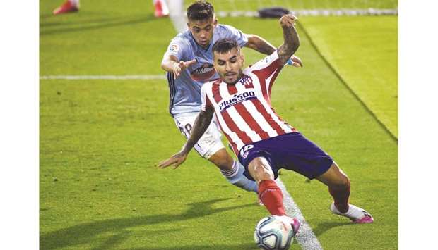 Celta Vigou2019s midfielder Fran Beltran (left) attempts a tackle on Atletico Madridu2019s forward Angel Correa during the La Liga match at the Balaidos stadium in Vigo, Spain, on Tuesday. (AFP)