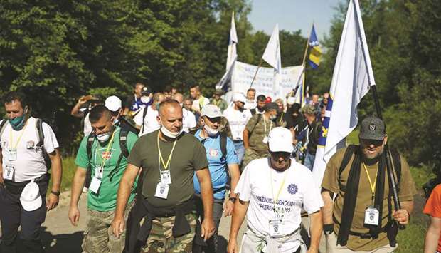 People walk through a forest near the village of Crni Vrh, Bosnia, on the u2018March of Peaceu2019, to retrace the route taken by Bosnian Muslims who fled Serb forces as they slaughtered 8,000 Muslims in 1995.
