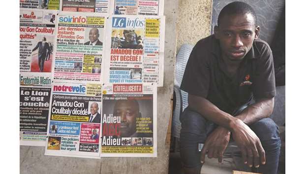 A man sits next to newspapers a day after the death of Ivory Coastu2019s Prime Minister Amadou Gon Coulibaly in Abidjan, yesterday.
