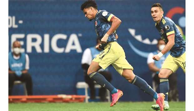Colombiau2019s Luis Diaz (left) celebrates after scoring the teamu2019s third goal against Peru during their Conmebol 2021 Copa America third-place match at the Mane Garrincha Stadium in Brasilia, Brazil. (AFP)