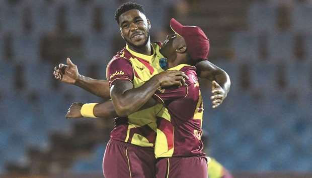 Obed McCoy (L) and Dwayne Bravo (R) of West Indies celebrate the dismissal of Josh Philippe of Australia at the Darren Sammy Cricket Ground in Gros Islet, Saint Lucia, on Friday.