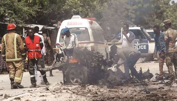 Rescuers, security and paramedics are seen at the scene of a car explosion near Benadir hospital in Mogadishu, Somalia yesterday.