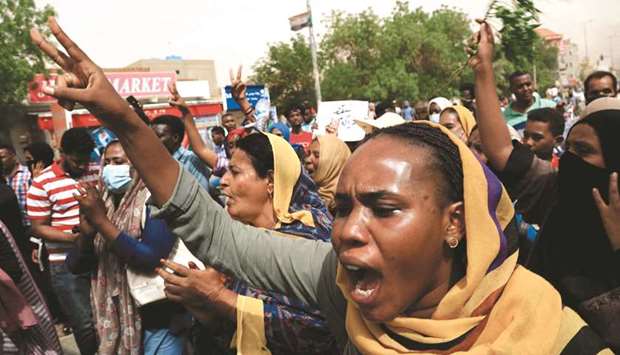 Sudanese march during a demonstration in the capital Khartoum urging the government to step down over delayed justice and recent harsh economic reforms, yesterday. The demonstrations were triggered by growing popular discontent against a recent government and IMF-backed reforms to slash subsidies on petrol and diesel more than doubling the price.