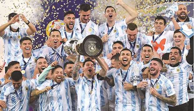 Argentinau2019s captain Lionel Messi (centre) holds the trophy as he celebrates on the podium with teammates after winning the CONMEBOL Copa America at Maracana Stadium in Rio de Janeiro on Saturday. (AFP)