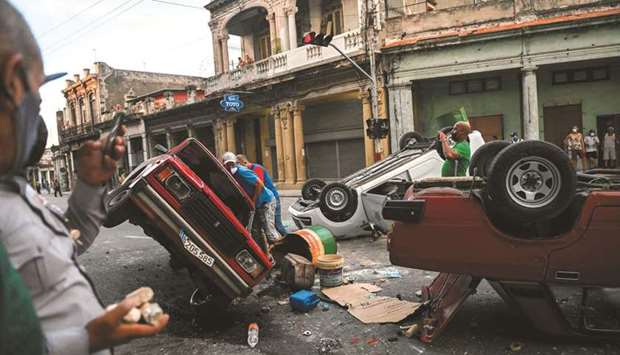 Police cars are seen overturned during a demonstration against Cuban President Miguel Diaz-Canel in Havana. (AFP)
