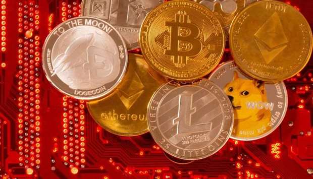 Representations of cryptocurrencies Bitcoin, Ethereum, DogeCoin, Ripple, Litecoin are placed on PC motherboard in this illustration taken, June 29. REUTERS
