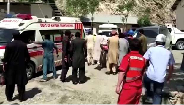 People wheel a gurney towards an ambulance outside a hospital in Dasu, after a bus with Chinese nationals on board plunged into a ravine in Upper Kohistan following a blast, Pakistan, in this still image taken from video. REUTERS