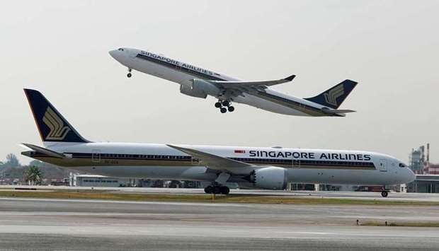 A Singapore Airlines Airbus A330-300 plane takes off behind a Boeing 787-10 Dreamliner at Changi Airport in Singapore - March 28, 2018. REUTERS