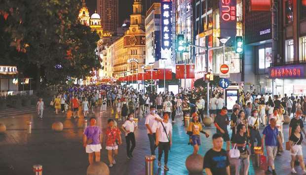 People visit a main shopping area in Shanghai on July 12. Chinau2019s GDP expanded 7.9% in the April-June quarter from a year earlier, official data showed on Thursday, missing expectations for a rise of 8.1% in a Reuters poll of economists.