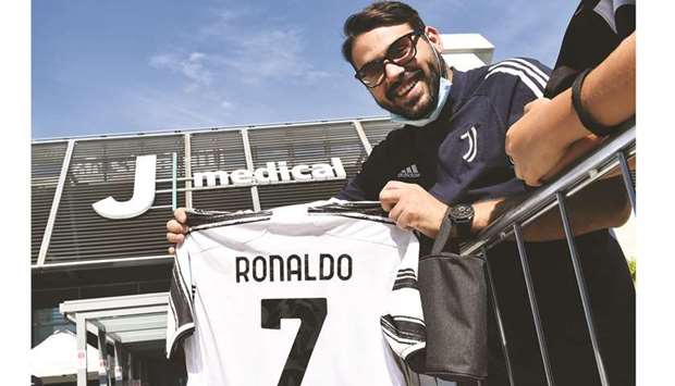 A fan is seen holding a Juventusu2019 Cristiano Ronaldo jersey in Turin yesterday. (Reuters)
