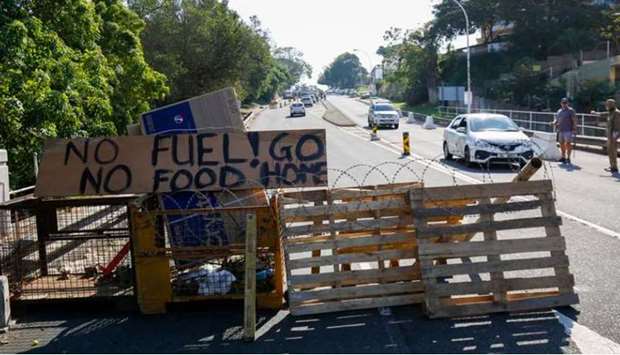 Community members monitor access to a suburb after several days of looting following the imprisonment of former South Africa President Jacob Zuma, in Durban, South Africa.