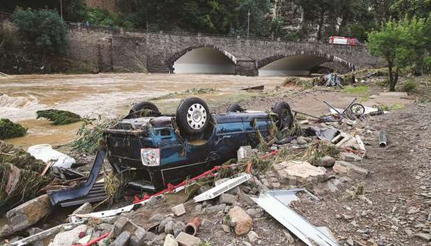 A destroyed car seen next to the Ahr river, following heavy rainfalls in Schuld, Germany yesterday. (Reuters)