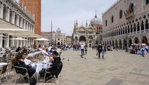 (File photo) People sit at outdoor tables at St. Mark's Square as Italy lifts quarantine restrictions for travellers arriving from European Union countries, Britain and Israel and begins offering COVID-free flights in a bid to revive the tourism industry, in Venice, Italy, recently. (Reuters)