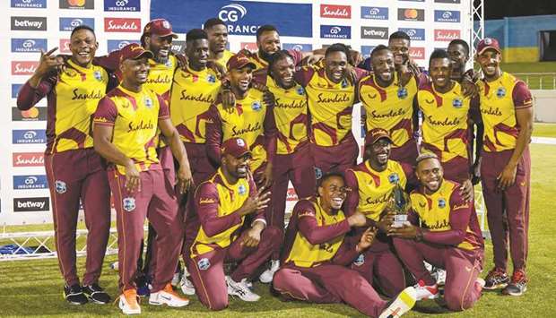 West Indies players celebrate with the trophy at the end of the 5th and final T20I against Australia at Darren Sammy Cricket Ground, Gros Islet, Saint Lucia. (AFP)