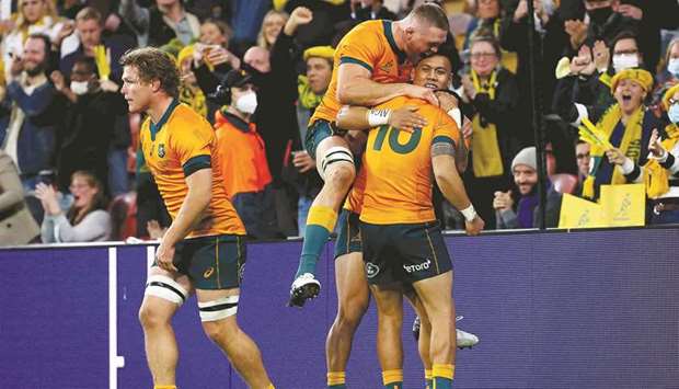 Australiau2019s Noah Lolesio (right) celebrates his try with teammates during the third Test against France in Brisbane yesterday. (AFP)