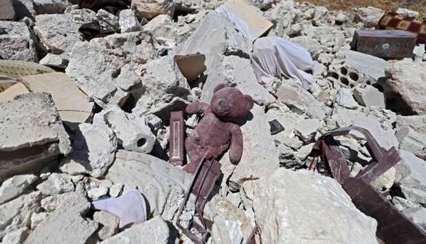 A child's teddy bear is pictured amidst the rubble of a house, following reported shelling by regime forces, in the village of Serja, in the southern part of Syria's Idlib province yesterday.