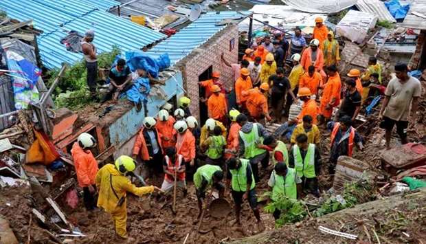 Rescue workers search for survivors after a residential house collapsed due to landslide caused by heavy rainfall in Mumbai, India