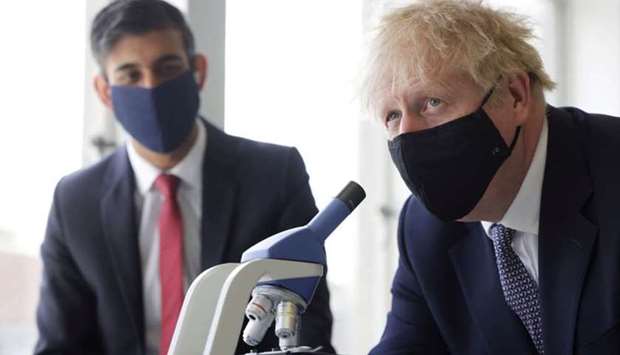 Britain's Prime Minister Boris Johnson and Chancellor of the Exchequer Rishi Sunak take part in a science lesson at King Solomon Academy in Marylebone, London, Britain, April 29. Dan Kitwood/Pool via REUTERS/File Photo