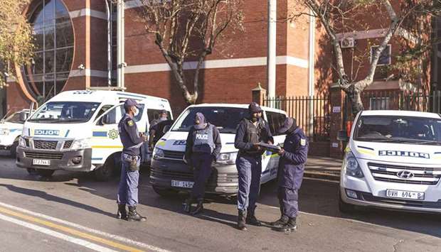 Members of the South African Police Services (SAPS) stand guard outside of the High Court, where the graft trial of ex-president Jacob Zuma resume in the southeastern city of Pietermaritzburg, on Monday.