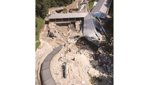 An areal view shows the devastated bobsleigh and luge track Koenigssee in Schoenau at Koenigssee, southern Germany, on Monday, after heavy rain hit parts of the country causing flooding. Koenigssee is the first artificially refrigerated sliding track in the world and hosts World Cup and world championship events. (AFP)