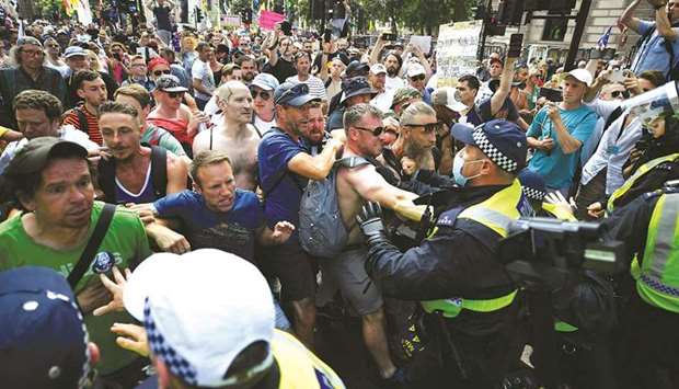 Protesters scuffle with police during u201cFreedom dayu201d demonstration, as most coronavirus restrictions were lifted in London, Britain, on Monday.