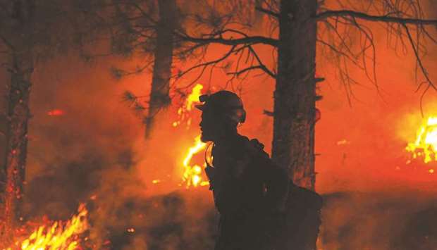 This photo obtained yesterday courtesy of the US Forest Service shows a firefighter during nighttime firefighting operations at the Bootleg Fire.