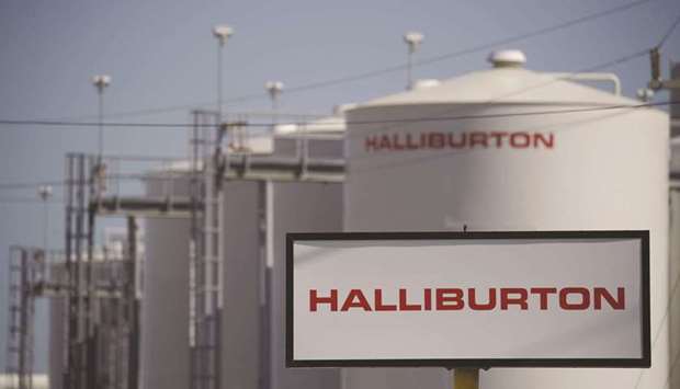 Halliburton Co signage is displayed alongside storage tanks in Port Fourchon, Louisiana. The biggest provider of fracking services, is gearing up for several years of expansion in both the US and foreign markets as spending recovers in the global energy industry.