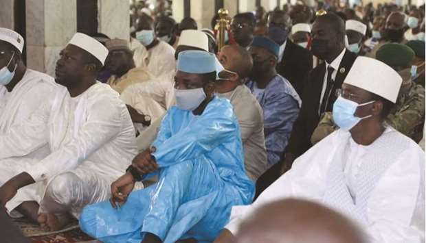 This image taken from video shows Maliu2019s interim president Assimi Goita (centre) as he sits with others during Eid al-Adha prayers at The Grand Mosque in Bamako, yesterday, before he was attacked.