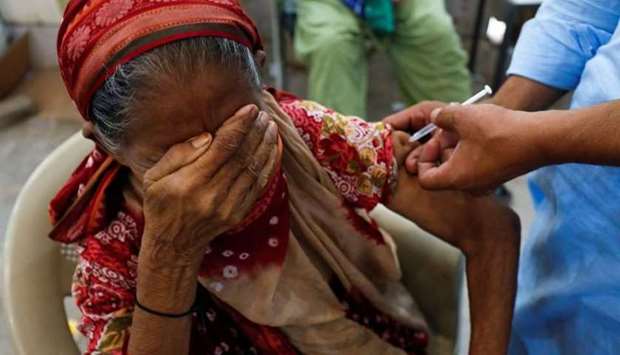 (File photo) Basanti, 71, reacts as she receives a dose of the coronavirus disease (COVID-19) vaccine at a vaccination center in Karachi, Pakistan recently. (REUTERS)