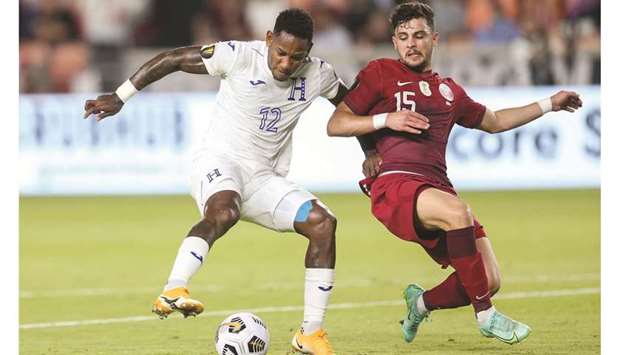 Hondurasu2019 Romell Quioto (left) and Qataru2019s Bassam al-Rawi vie for the ball during the CONCACAF Gold Cup group stage match at BBVA Stadium in Houston, Texas, on Tuesday night. (USA TODAY Sports)