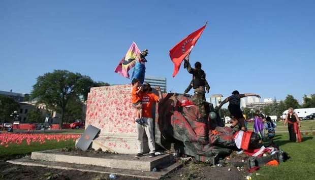 A defaced statue of Queen Victoria lies after being toppled during a rally, following the discovery of the remains of hundreds of children at former indigenous residential schools, outside the provincial legislature on Canada Day in Winnipeg, Manitoba, Canada yesterday. REUTERS