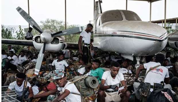 Soldiers of Tigray Defence Force (TDF) take a shelter from rain at Tigray Martyr's Memorial Monument Center in Mekele, the capital of Tigray region, Ethiopia, on June 30