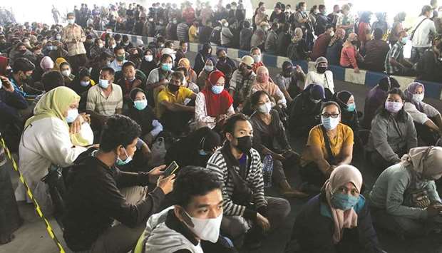 People wearing protective face masks queue for the coronavirus vaccine at Juanda International Airport as cases surge in Sidoarjo, East Java Province, Indonesia.