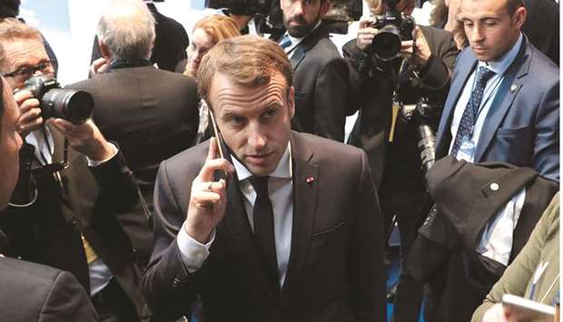 This photo taken on November 17, 2017 shows President Macron on the phone during the European Social Summit in Gothenburg, Sweden. He called an urgent national security meeting yesterday to discuss the Israeli-made Pegasus spyware after reports about its use in France emerged this week, a government spokesman said.