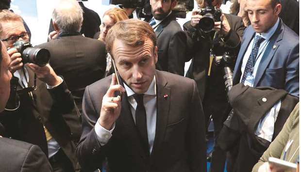 This photo taken on November 17, 2017 shows President Macron on the phone during the European Social Summit in Gothenburg, Sweden. He called an urgent national security meeting yesterday to discuss the Israeli-made Pegasus spyware after reports about its use in France emerged this week, a government spokesman said.