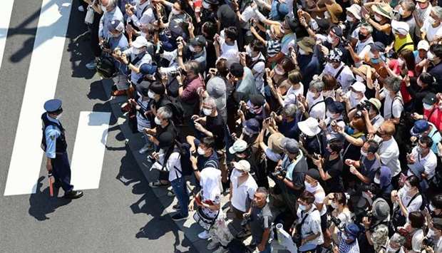 Arrival Ceremony for Tokyo 2020 Olympic Torch Relay - Shinjuku City, Tokyo- People wearing face masks watch the Japan air force aerobatic squadron Blue Impluse