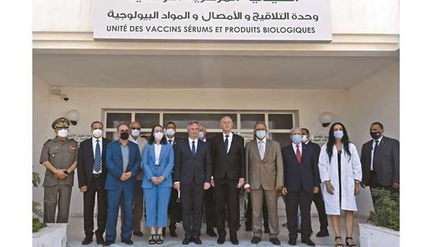 Tunisiau2019s President Kais Saied and Franceu2019s Secretary of State for Tourism, French living abroad, and Francophonie Jean-Baptiste Lemoyne (centre left) pose for a picture with staff and officials at the headquarters of the central pharmacy in the capital Tunis yesterday, during a ceremony to receive French aid to combat Covid-19.