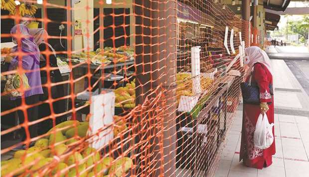 A wet market is cordoned off to limit entry and exit points in Singapore.