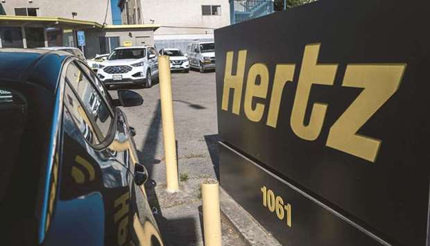 Signage for Hertz Global Holdings stands at a rental location in Berkeley, California. The latest round of drama for Hertz concerns its newly re-launched shares, which can be bought and sold by individuals on the open market for about $17. But insiders who got their stakes as part of the auto rental companyu2019s recent bankruptcy settlement can trade only with other professionals in private markets, at least for now.