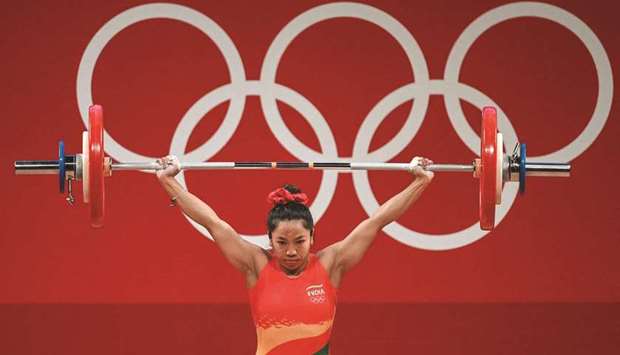 Indiau2019s Chanu Saikhom Mirabai competes in the womenu2019s 49kg weightlifting competition during the Tokyo 2020 Olympic Games in Tokyo yesterday. (AFP)