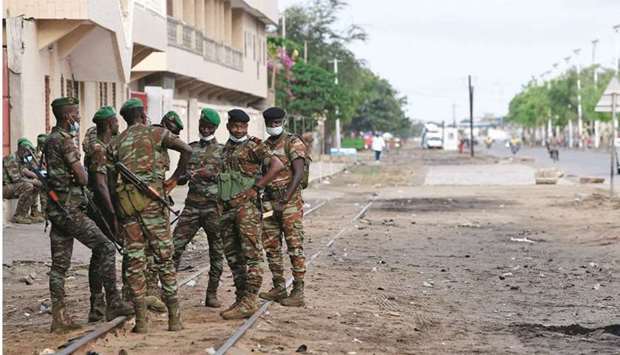 File photo taken on April 11, 2021 shows Benin soldiers stand outside a polling station during the Presidential election in Cotonou.