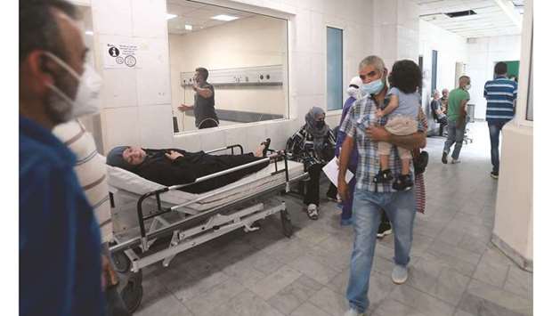 A patient rests on a bed in a hallway of the Rafik Hariri University Hospital (RHUH) in Lebanonu2019s capital Beirut.