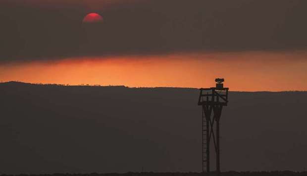 The sun is seen partially obscured by smoke from the Bootleg Fire, just before sunset on Friday in Paisley, Oregon.