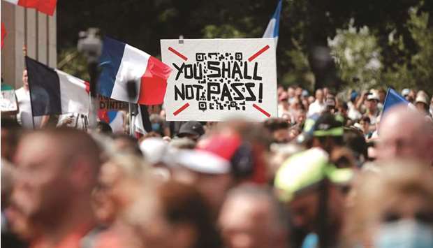 A protester holds a placard during a demonstration called by the French nationalist party u201cLes Patriotesu201d (The Patriots) against Franceu2019s restrictions to fight the coronavirus outbreak, on the u201cDroits de lu2019Hommeu201d (human rights) esplanade at the Trocadero Square in Paris yesterday. (Reuters)