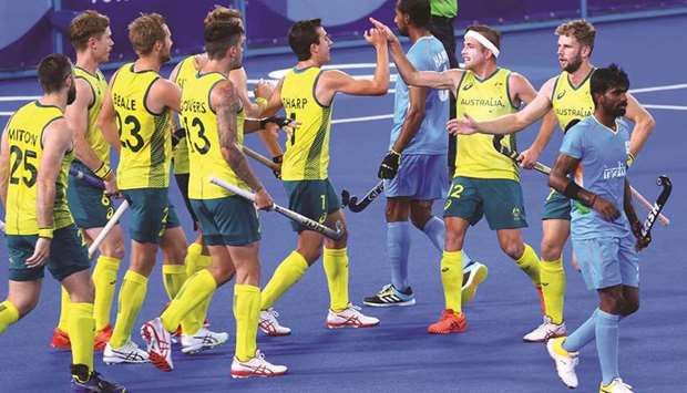 Australia players celebrate after scoring a goal against India in Tokyo yesterday. (Reuters)
