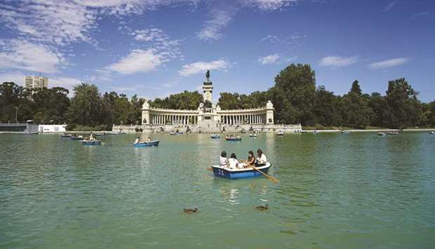 People swim in row boats on a lake at El Retiro Park in Madrid on the day Madridu2019s historic Paseo del Prado boulevard and Retiro Park were added as world heritage sites. (Reuters)