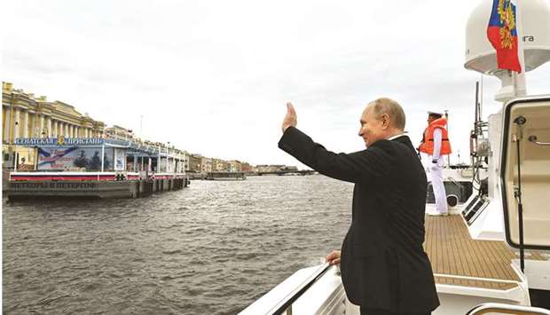 President Vladimir Putin waves as he attends the Navy Day parade in St Petersburg yesterday. (AFP)