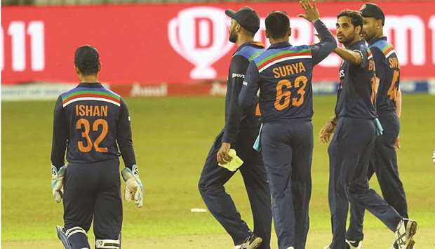 Indiau2019s Bhuvneshwar Kumar (second right) celebrates after taking a Sri Lankan wicket in the opening T20 match in Colombo yesterday. (BCCI)
