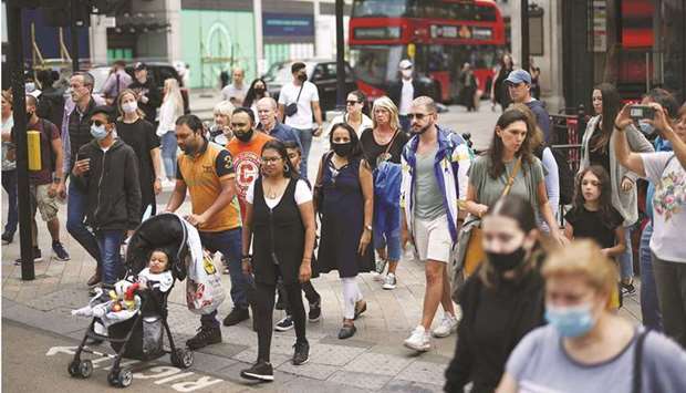 People walk through Oxford Circus, amid the coronavirus outbreak, in London yesterday.